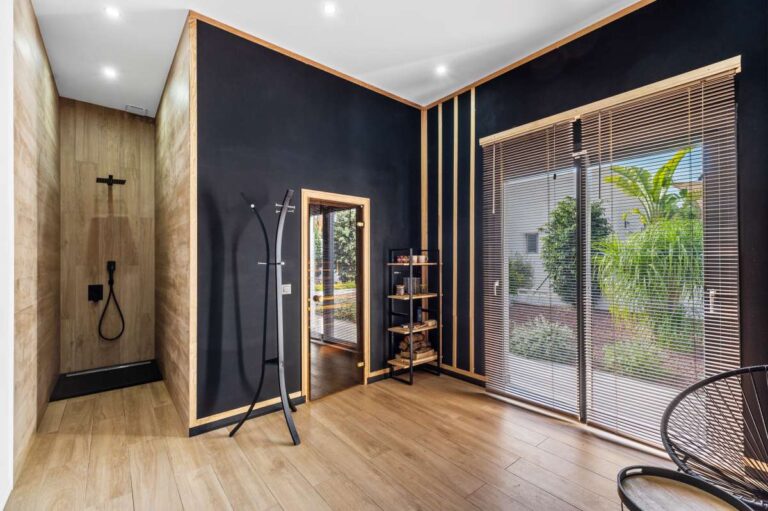 Wellness area inside a single-level modern villa in Santa Clara, Altea with sauna access, walk-in shower, garden views and contemporary interior finish