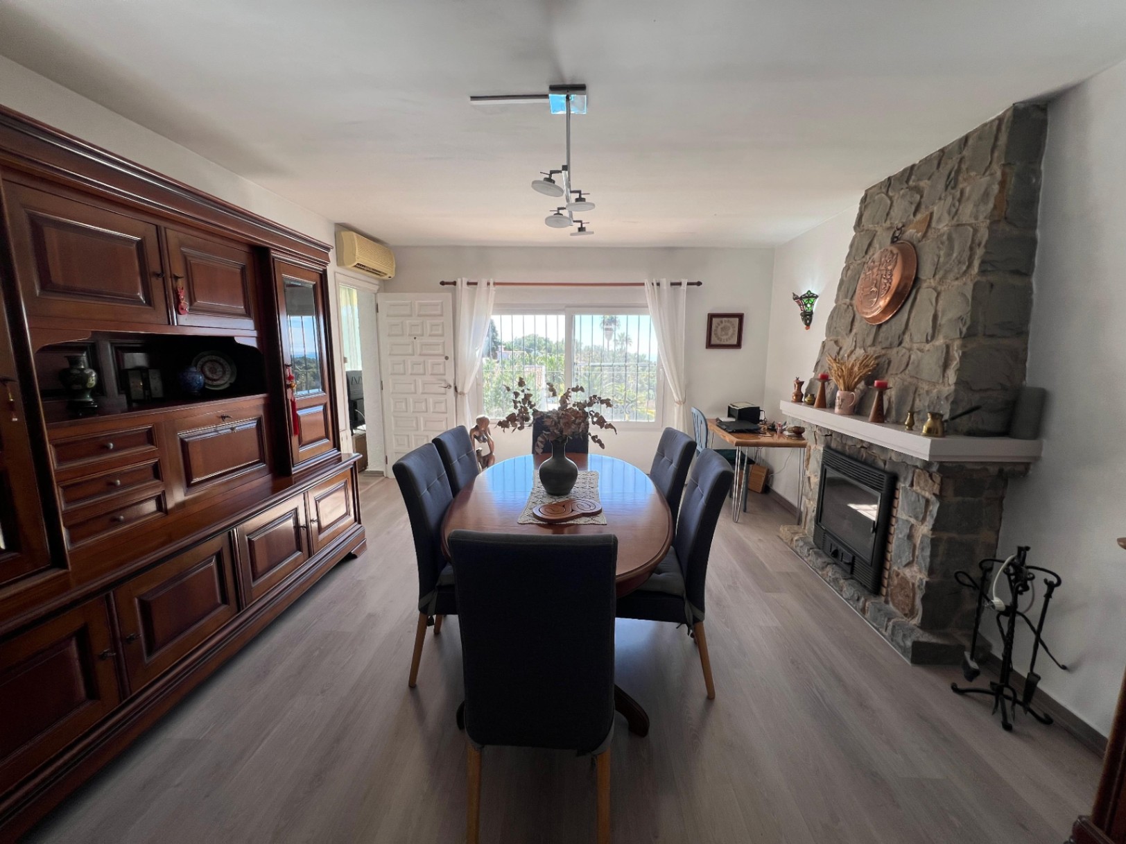 Dining room with fireplace at Mediterranean villa in Buena Vista Benissa