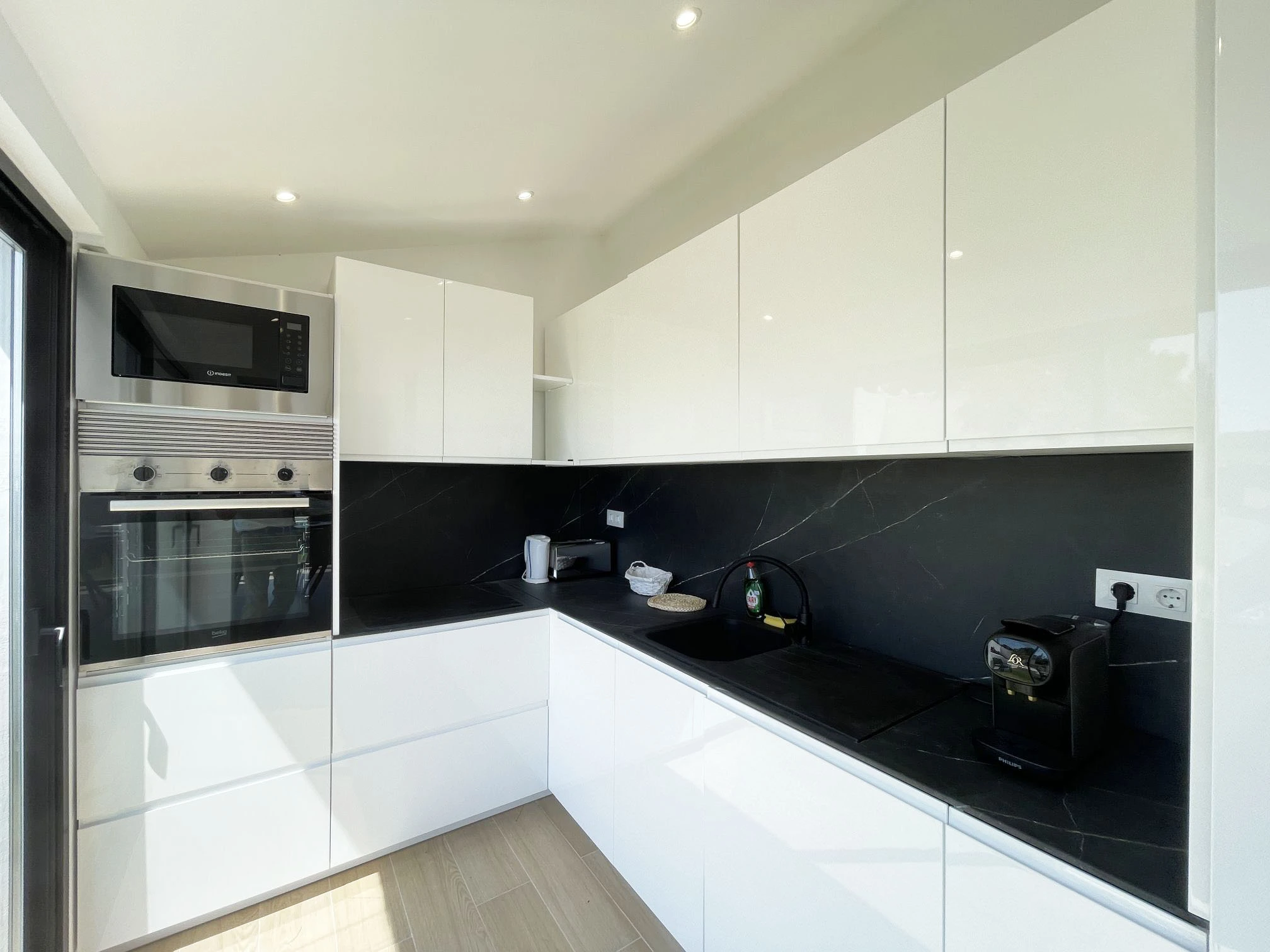 White and black kitchen inside Oltamar villa in Calpe
