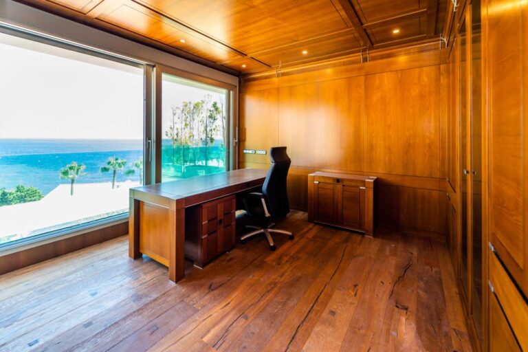 Wooden office inside a luxury villa in Calpe with built-in storage, desk area and Mediterranean Sea views through large windows