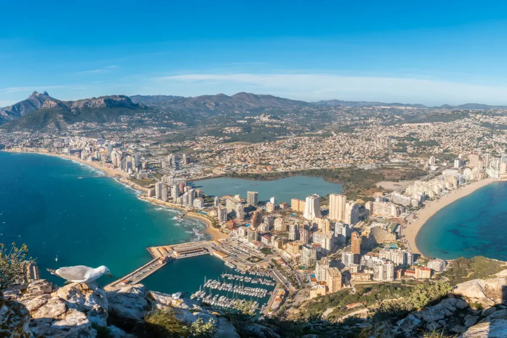 Aerial view of Calpe from the Peñón de Ifach showing the marina, beaches, apartments and coastline for a property market article