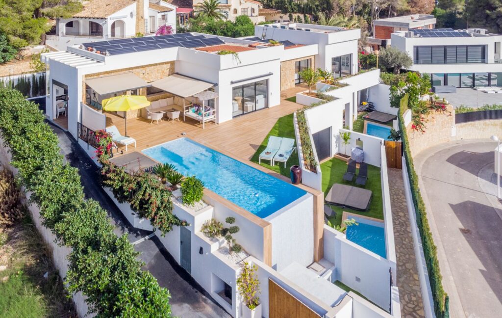 Aerial view of a modern villa in Pla del Mar, Moraira with sea views, heated swimming pool, guest apartments, terraces and contemporary exterior