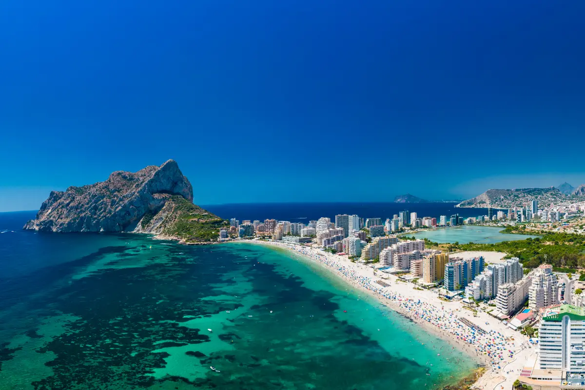 Aerial view of La Fossa Beach in Calpe with Peñón de Ifach, beachfront apartments and the Mediterranean coastline