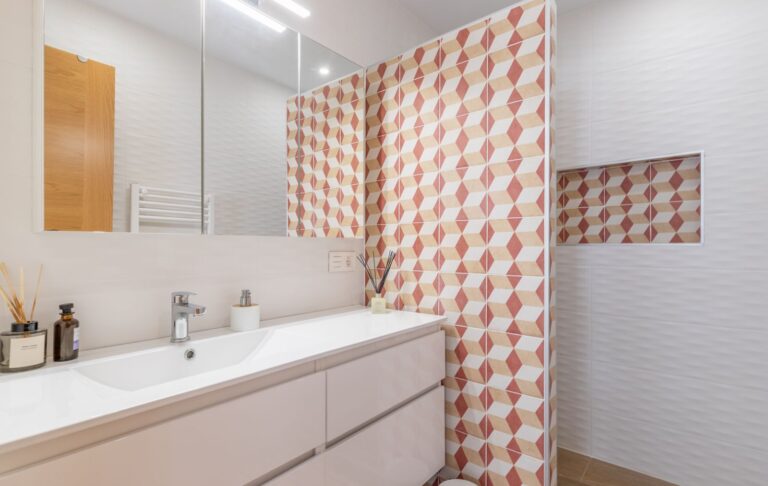 Bathroom inside a modern villa in Pla del Mar, Moraira with vanity unit, large mirror, patterned shower tiles and contemporary finish