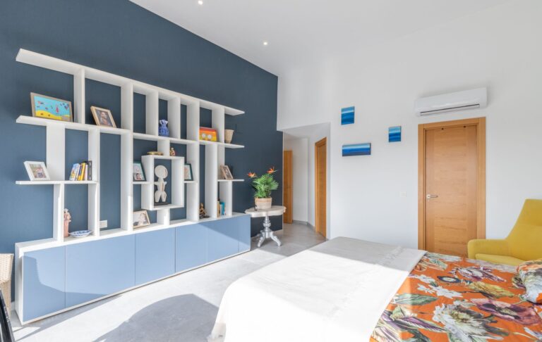 Bedroom inside a modern villa in Pla del Mar, Moraira with fitted shelving, air conditioning, double bed and contemporary interior design