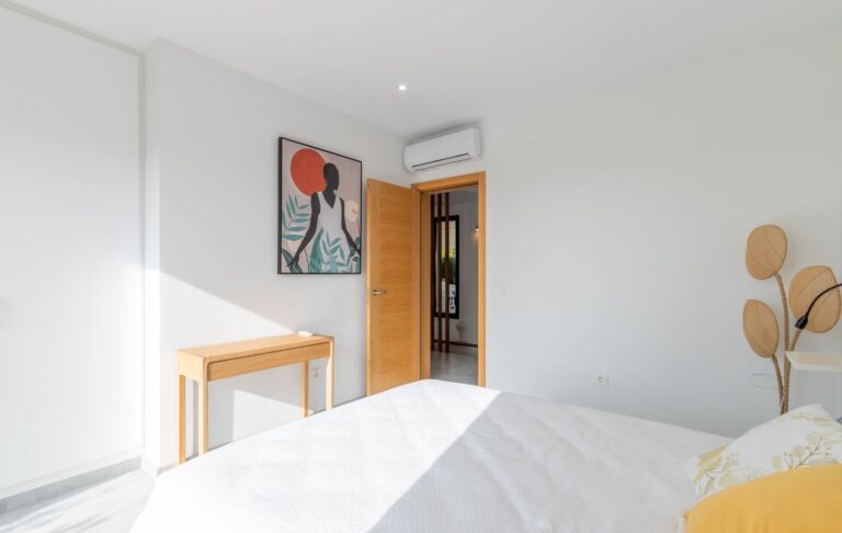 Bedroom inside a modern villa in Pla del Mar, Moraira with fitted wardrobes, air conditioning, double bed and contemporary neutral interior
