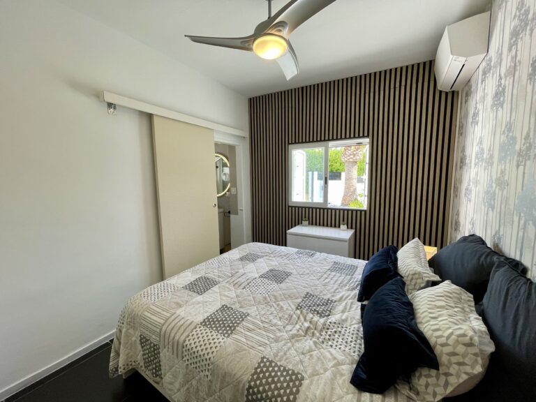 Bedroom with built-in storage, ceiling fan and air conditioning in a Calpe villa
