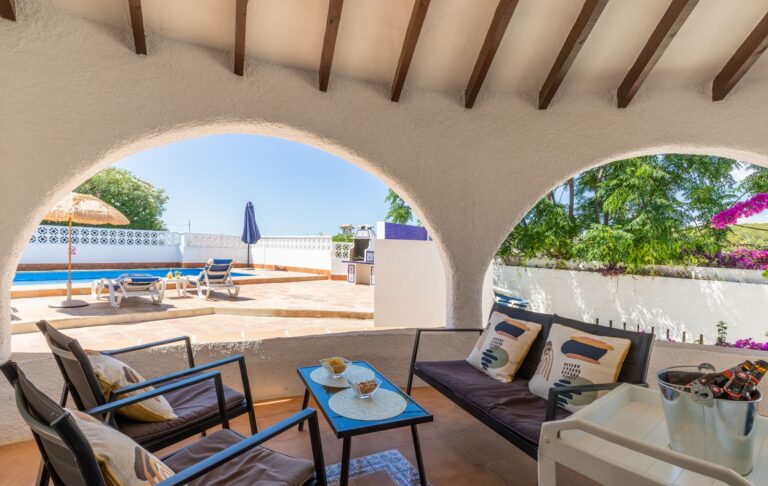 Covered naya at a renovated Mediterranean villa near Cala Baladrar in Benissa Costa with outdoor seating, arched openings and private pool views