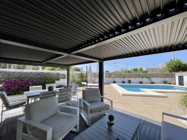 Covered outdoor lounge area overlooking the private pool at a villa in Calpe