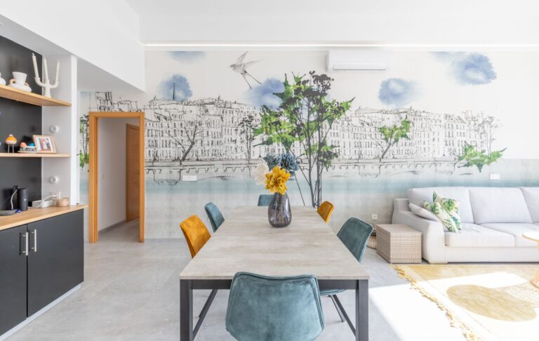 Dining and living area inside a modern villa in Pla del Mar, Moraira with open-plan layout, feature wall, sofa seating and bright natural light