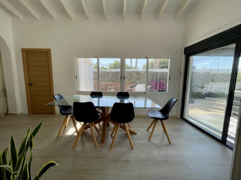 Dining room with large glass doors leading to the terrace at a villa in Calpe