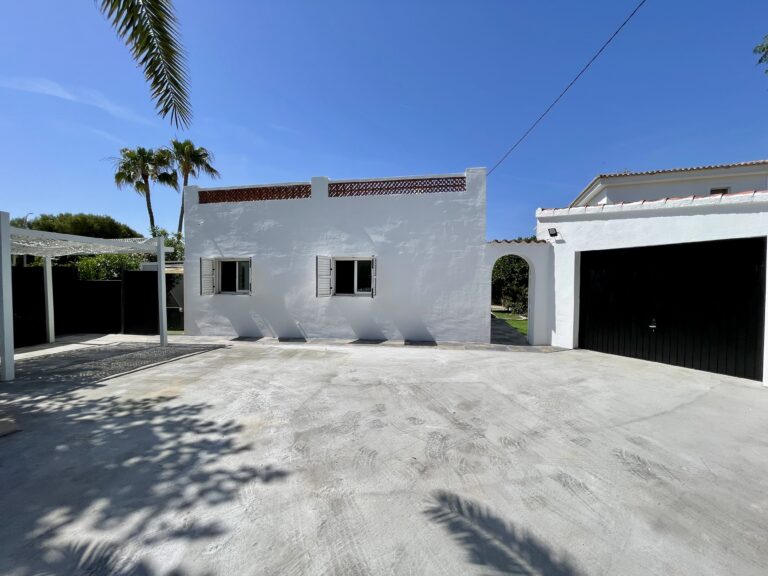 Exterior view of a Calpe villa with private garage and parking area