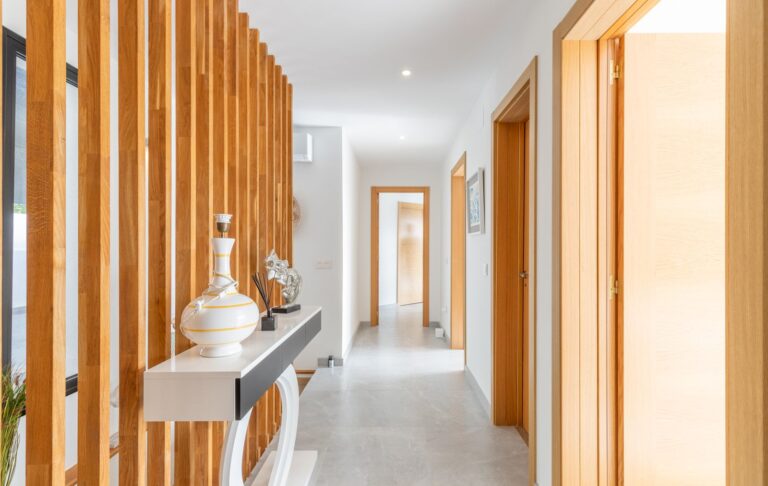Hallway inside a modern villa in Pla del Mar, Moraira with vertical wood detail, bright corridor, contemporary finish and bedroom access