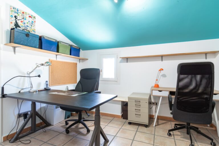 Home office inside a renovated finca near Teulada and Moraira with two desks, bright window, turquoise ceiling and tiled flooring