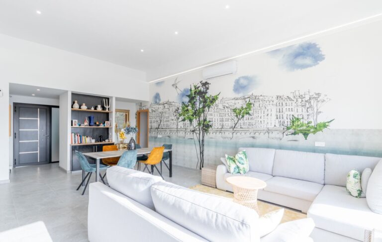 Living area inside a modern villa in Pla del Mar, Moraira with feature wall, sofa seating, built-in shelving and bright contemporary design