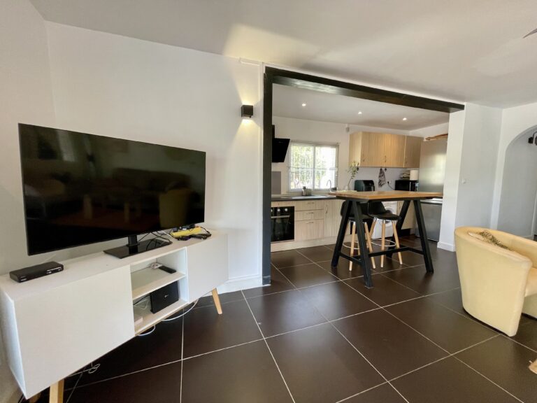 Living room with TV area and open kitchen in a villa for sale in Calpe