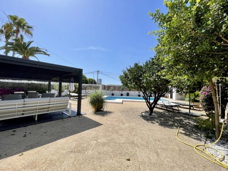Low-maintenance garden with private pool and shaded terrace at a villa in Calpe