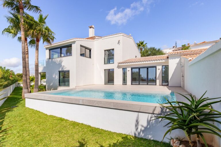 Luxury smart home villa near Moraira with private swimming pool, white contemporary exterior, garden area and Mediterranean outdoor space