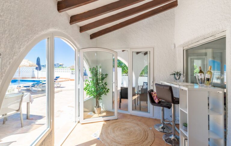 Naya at a renovated Mediterranean villa near Cala Baladrar in Benissa Costa with pool access, arched openings, beamed ceiling and outdoor seating
