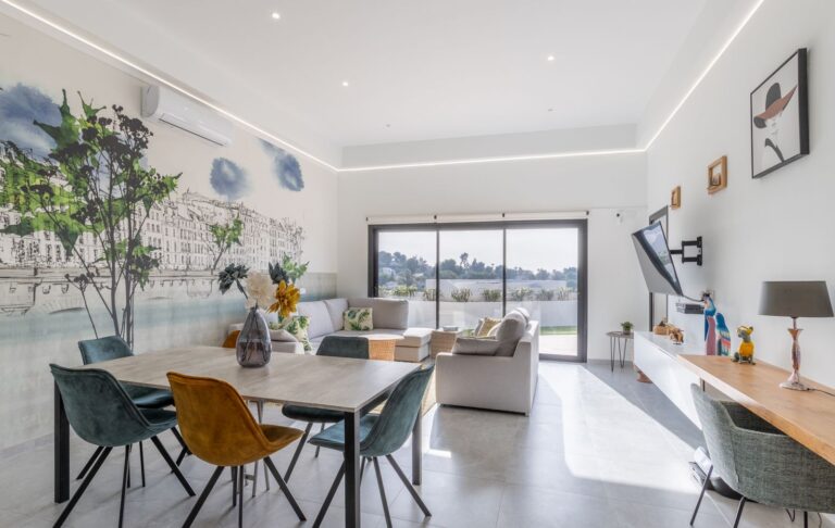 Open-plan living and dining room inside a modern villa in Pla del Mar, Moraira with sea views, large windows, contemporary furniture and bright interior