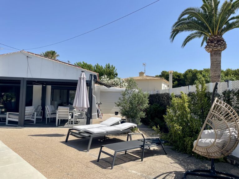 Outdoor terrace with pool, loungers and Mediterranean planting at a Calpe villa