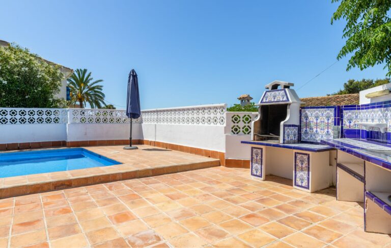 Pool terrace at a renovated villa near Cala Baladrar in Benissa Costa with private swimming pool, built-in barbecue, tiled terrace and outdoor dining space