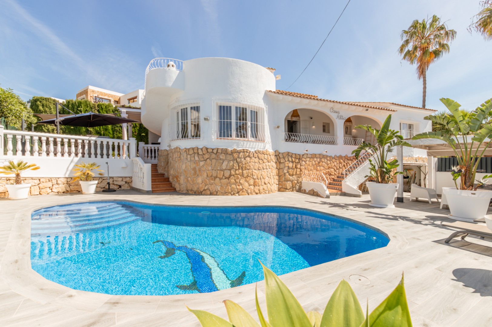 Renovated Mediterranean villa in Moraira with private swimming pool, curved exterior, covered terrace, stone details and sunny outdoor space
