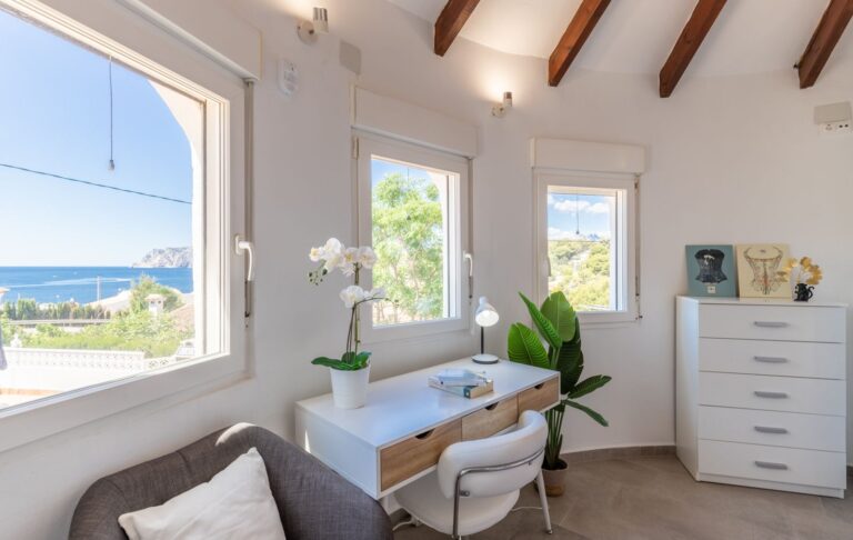 Study area inside the tower room of a renovated villa near Cala Baladrar in Benissa Costa with sea views, desk, windows and bright interior