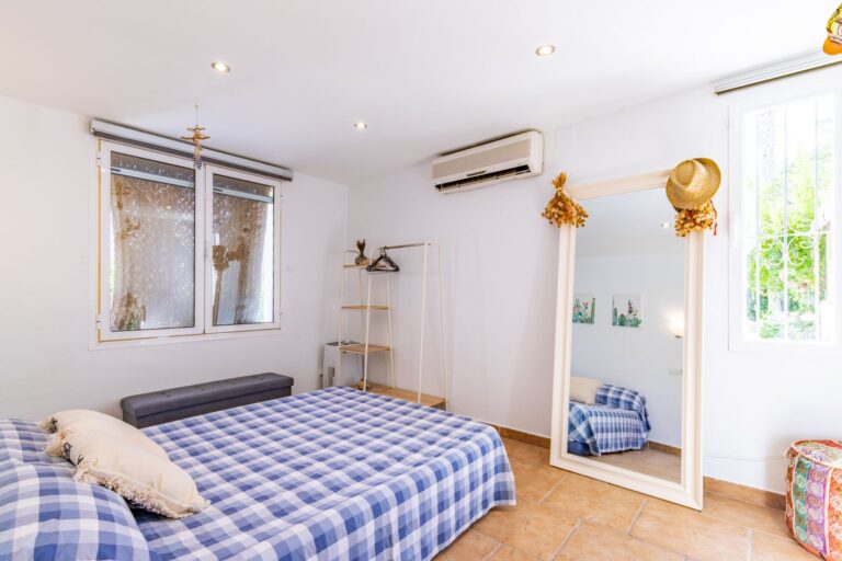 Third double bedroom inside a Mediterranean villa near Cala Baladrar in Benissa Costa with air conditioning, window, tiled floor and bright neutral finish