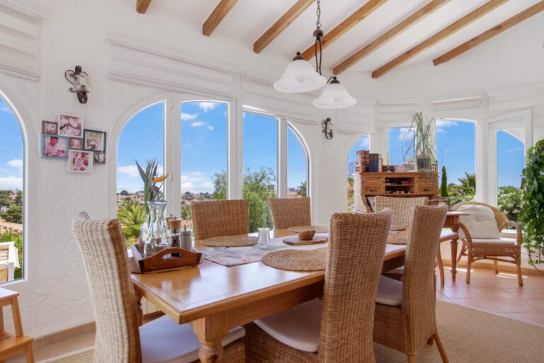 Dining room with large arched windows and panoramic sea views in a Calpe villa