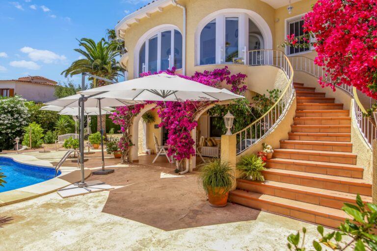 Exterior staircase with bougainvillea beside the pool at a villa in Calpe