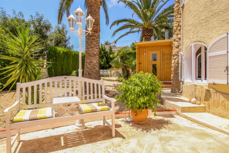 Garden seating area with private sauna at a sea view villa in Calpe