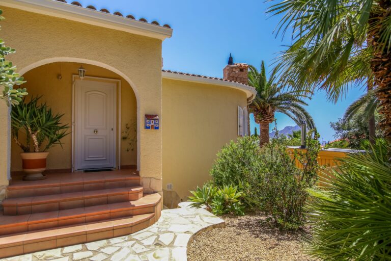 Main entrance with landscaped garden at a sea view villa in Calpe