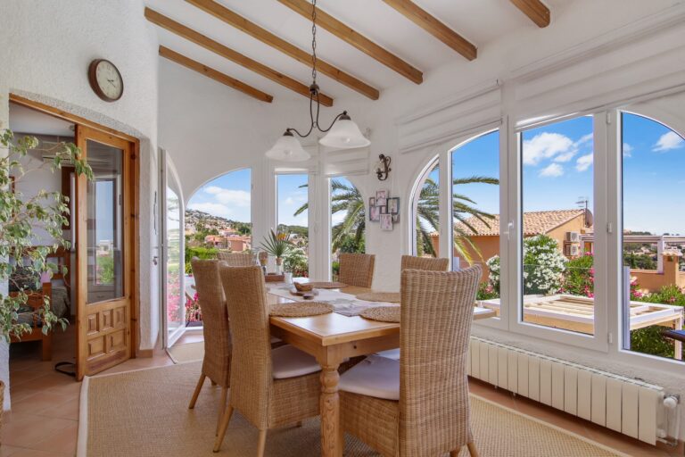 Sea view dining room with arched windows in a Mediterranean villa for sale in Calpe