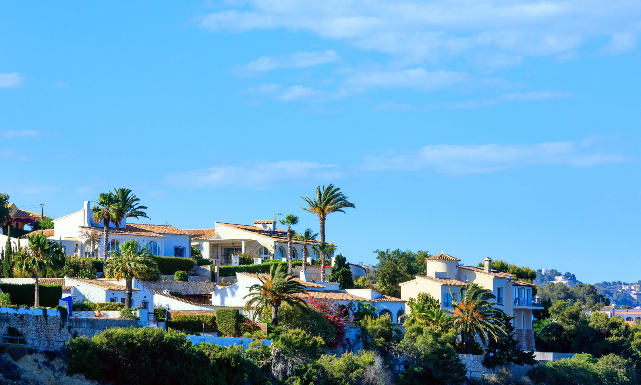 Mediterranean villas with palm trees in Calpe on the Costa Blanca