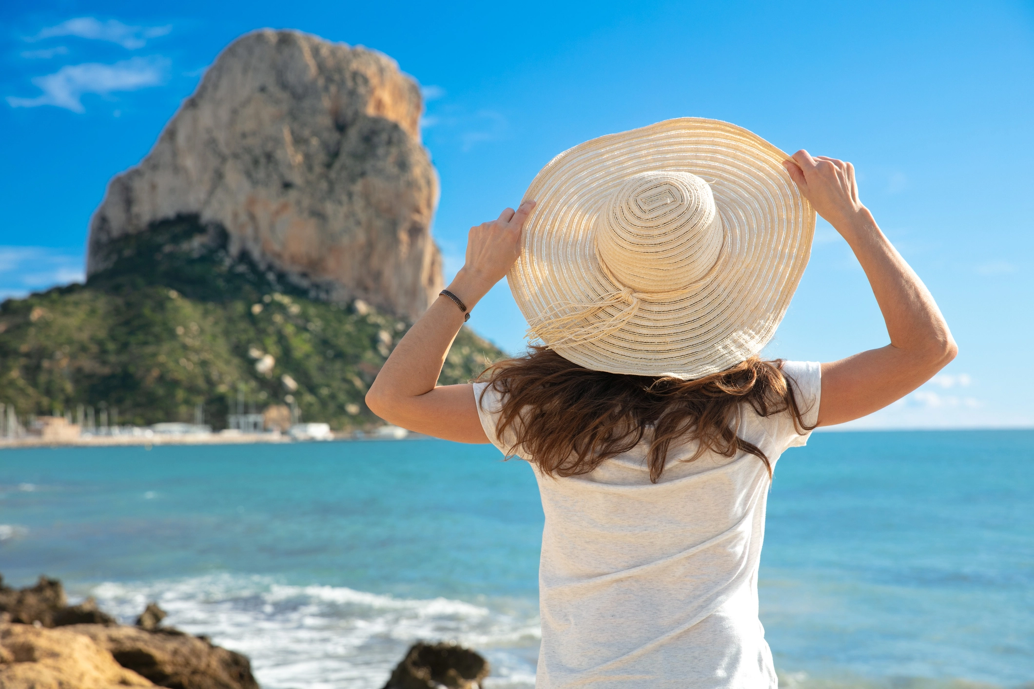 Woman overlooking the Mediterranean and Peñón de Ifach in Calpe, Spain
